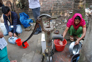 Slum dwellers use aluminum pots knows as kolshis and plastic bottles to gather their water. 
