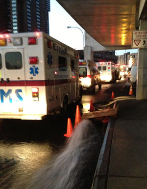 water gushes out of a pump at Bellevue as ambulances idle and wait for patients during the evacuation on Nov. 1.